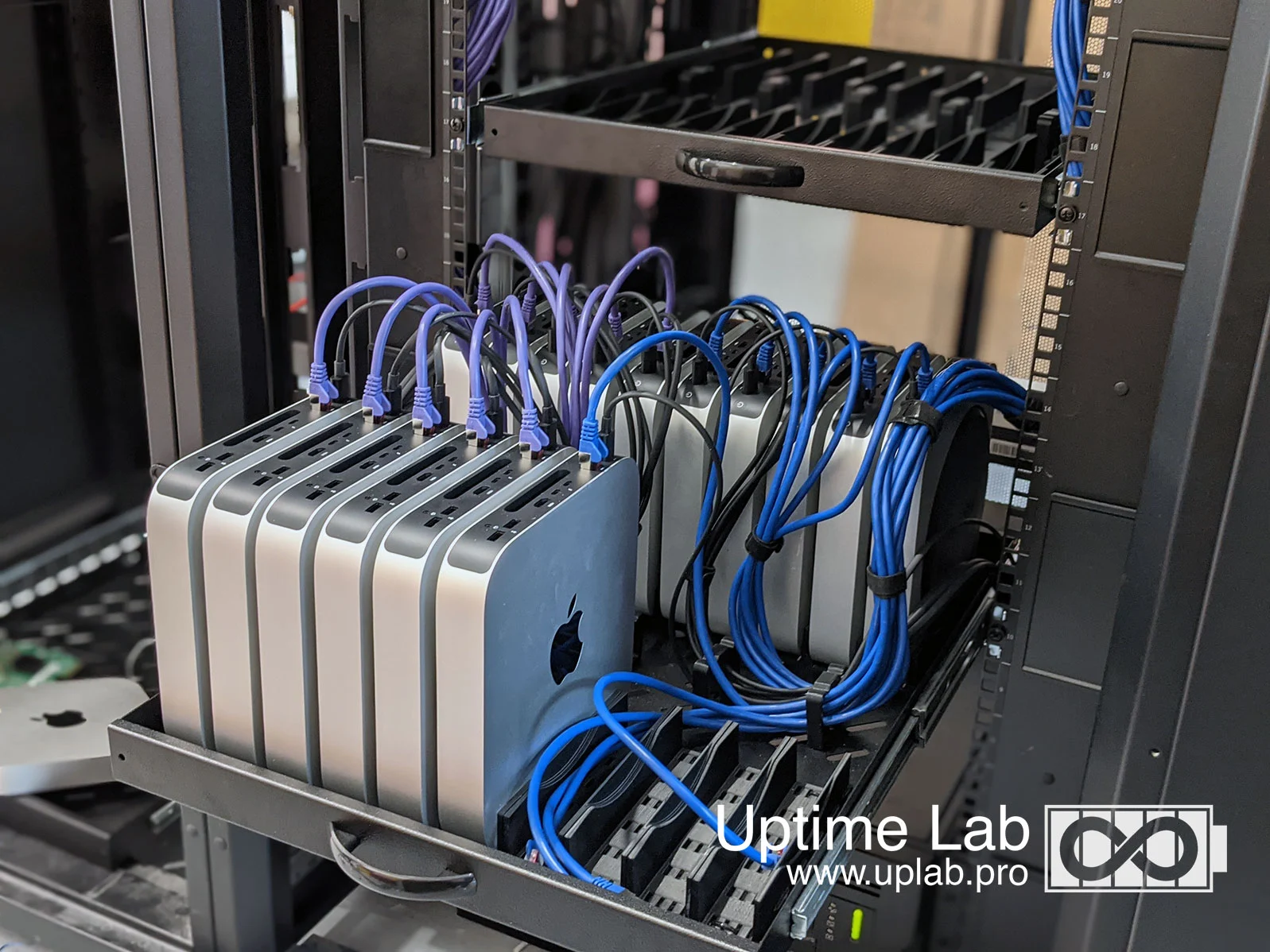 Outro cluster de Mac mini/Studio em rack, com cabeamento organizado